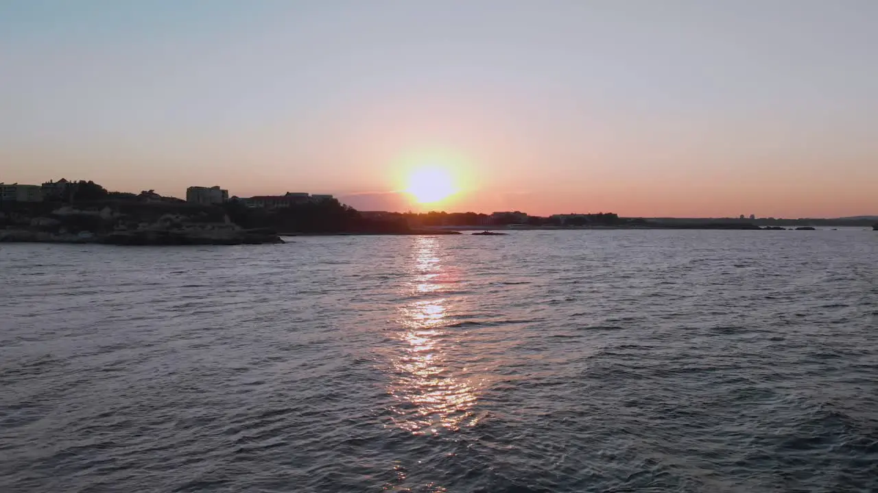 Aerial shot of sunset above the port Lozenets  Bulgaria filmed by drone flying down to the water