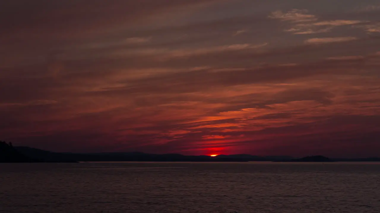 Time-lapse of wildfire smoke obscurring the sunset over the shore of Lake Superior