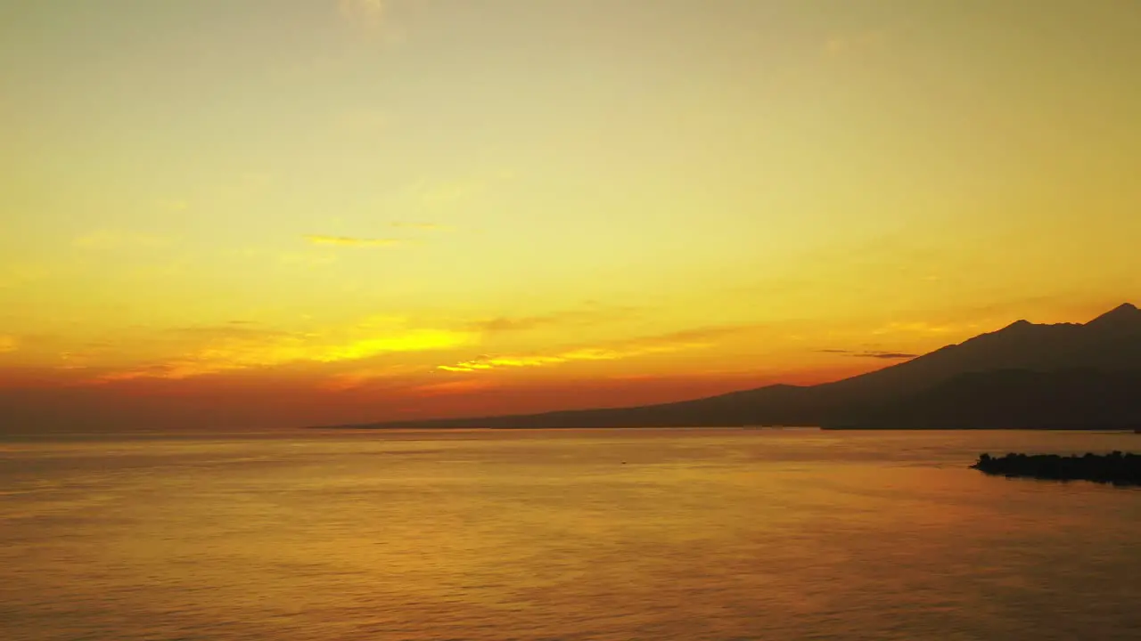 Aerial panning view of a golden sunset in the popular holiday location of Indonesia