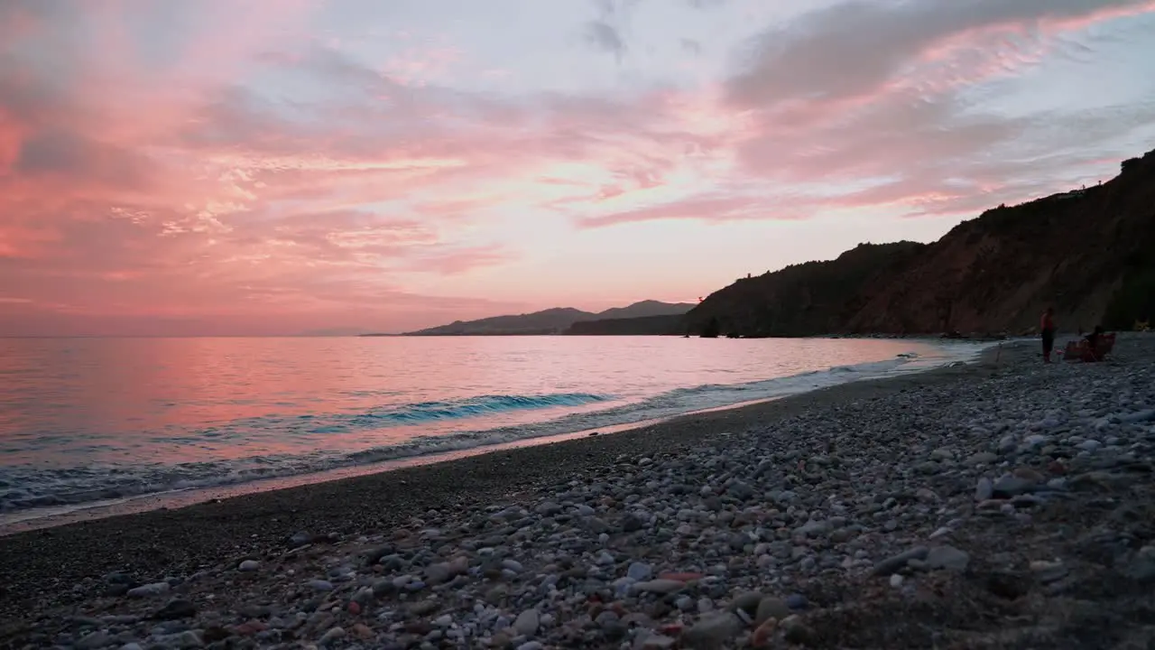 Red sunset at a pebble beach