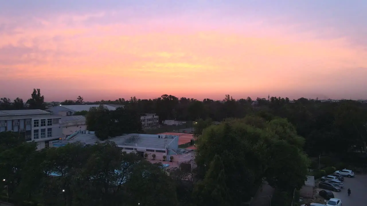 4K Drone Shots of a Sunset in an Indian City New Delhi above trees and houses beautiful light punjabi bagh club posh colony