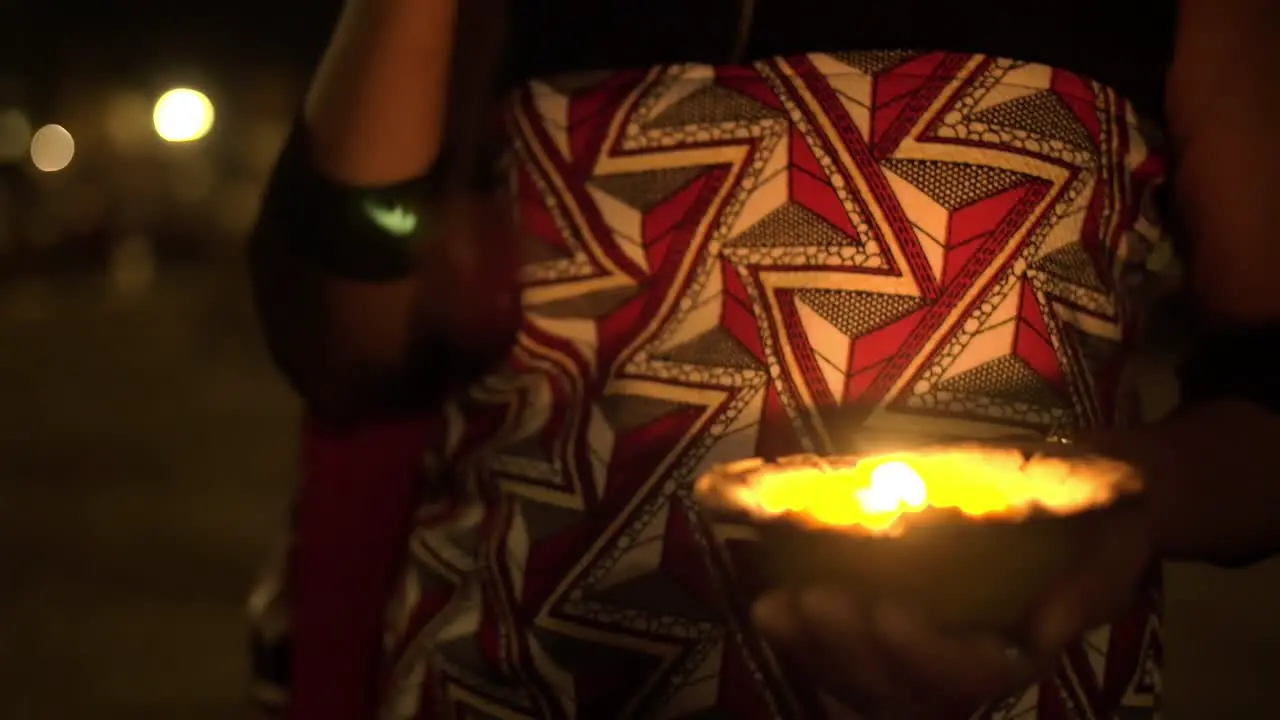 Woman Praying and Holding Puja Candle at Ceremony