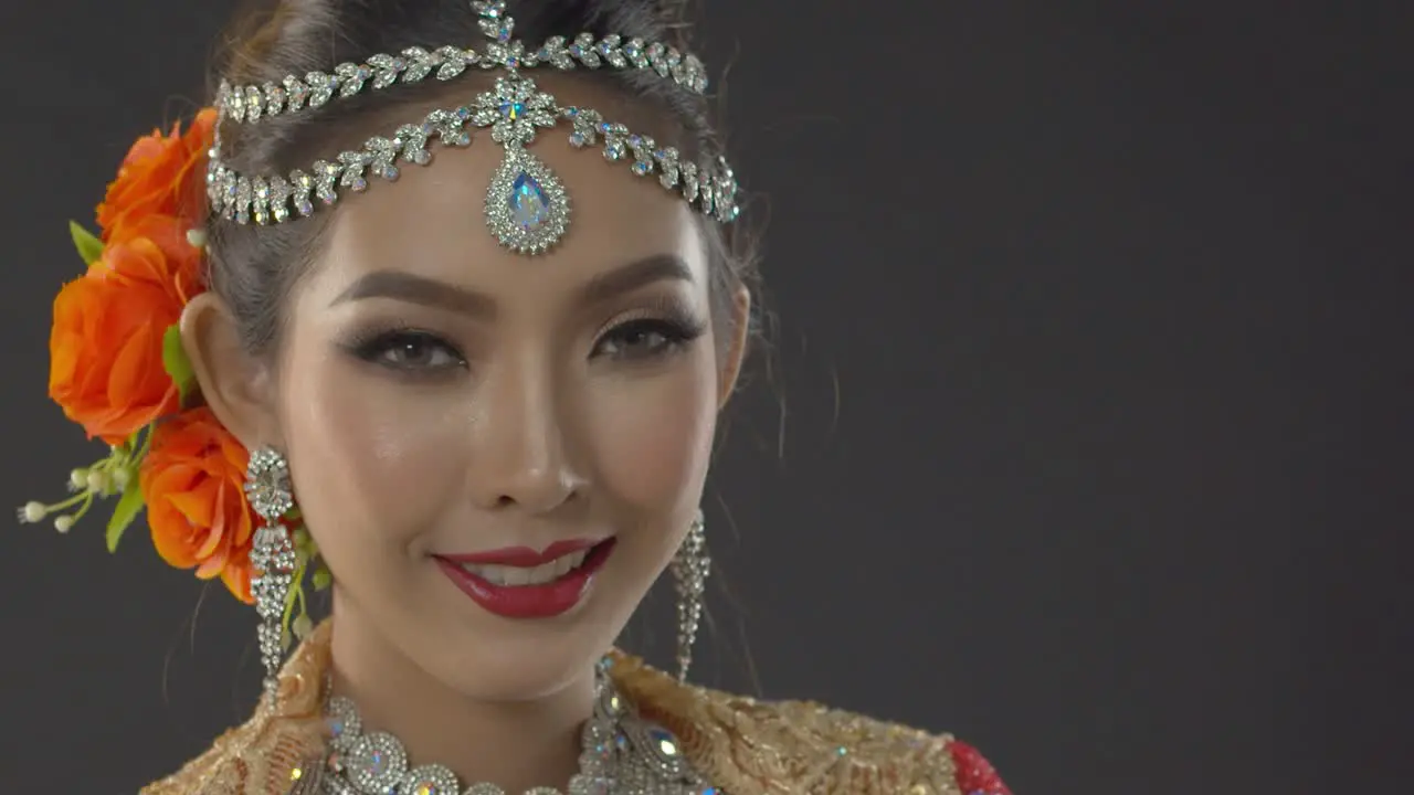 Portrait of an Indian bride with traditional makeup and jewelry on her wedding day close up static poses