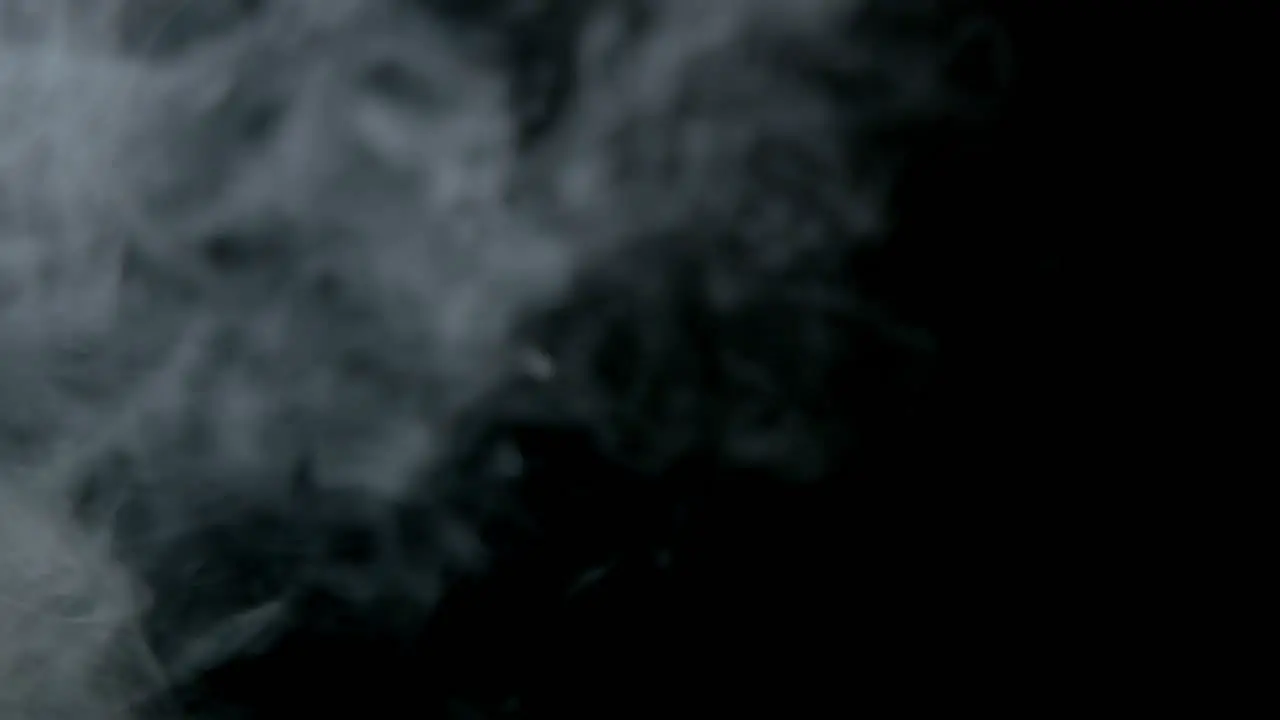 Smoke vapour against a black backdrop passing frame