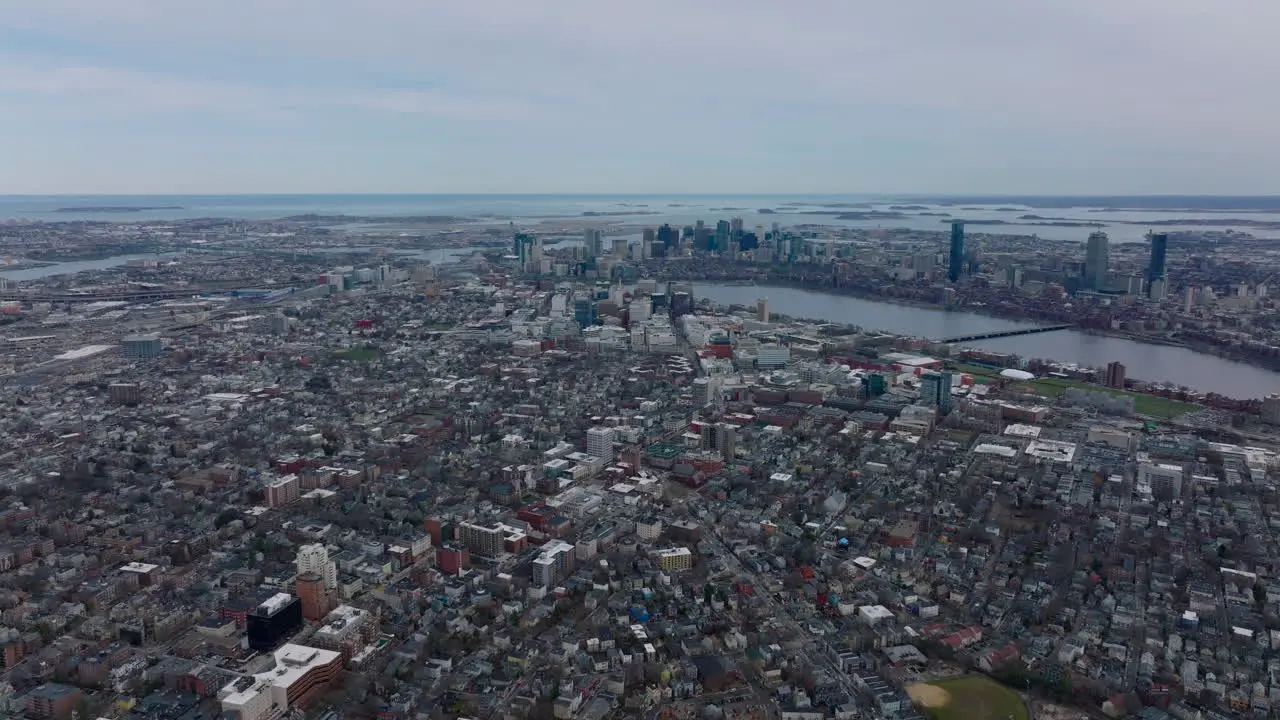 Aerial panoramic descending footage of city Fly high above buildings in residential neighbourhood Boston USA