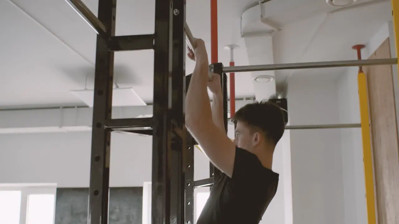 A Fitness Young Male Does Pull Ups In The Gym