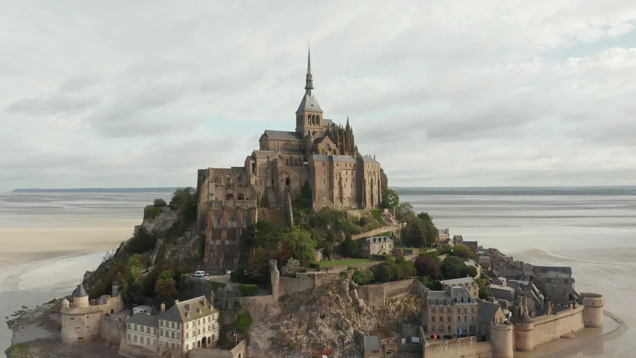 Wide View of Le Mont Saint Michel Castle in the Ocean in France Aerial Cloudy