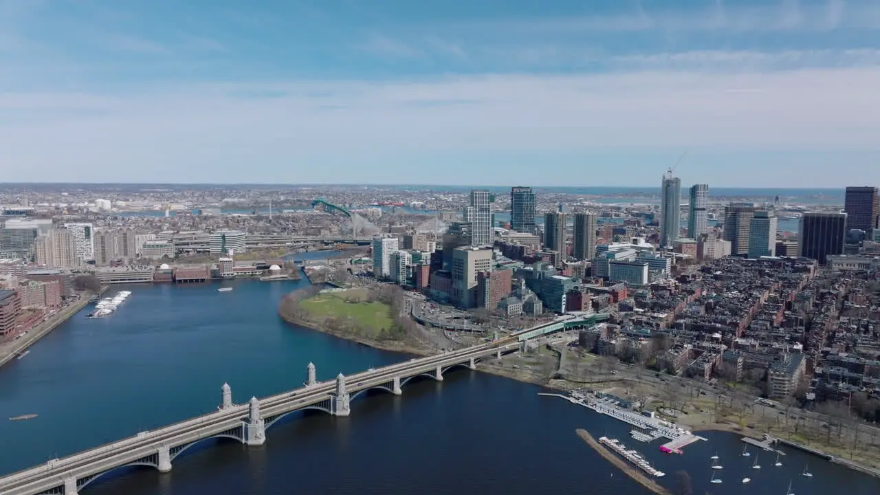 Aerial panoramic view of Longfellow Bridge over Charles river busy multilane road on waterfront and high rise buildings protruding above other development Boston USA