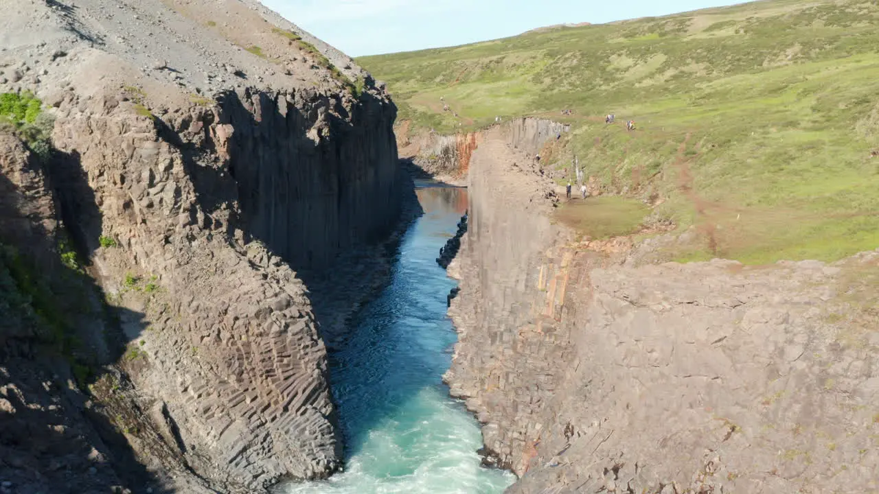 Aerial view of Jokulsa river flowing through columns of volcanic basalt formations in Stuolagil canyon in Iceland Drone view of glacier water river streaming in Vatnajokull national park