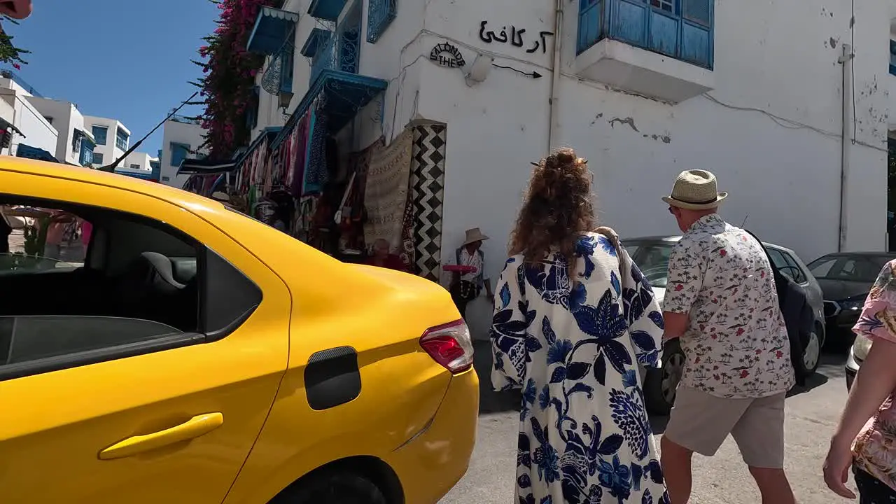 Walking in Sidi Bou Said Street with group of tourists in Tunisia