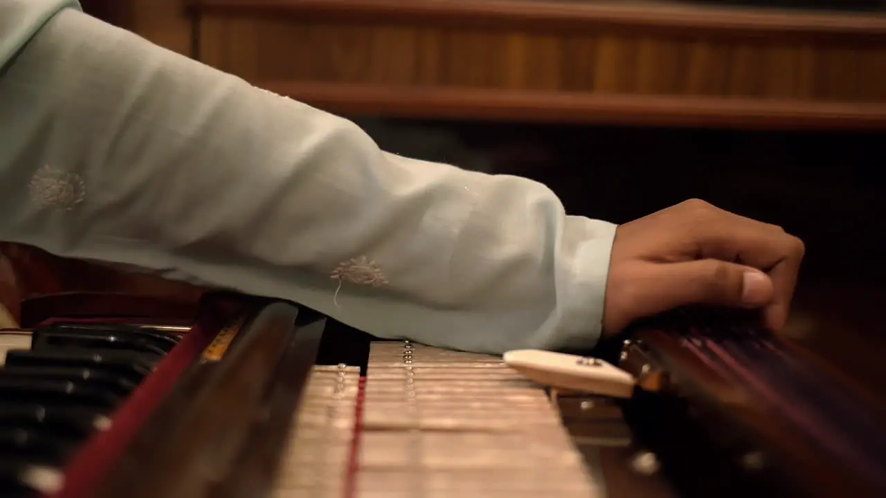 Panning Shot of a Man Playing the Harmonium