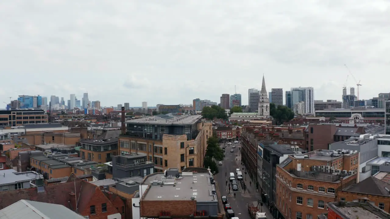 Aerial panoramic view of urban neighbourhood Descending footage with modern skyscrapers in background London UK