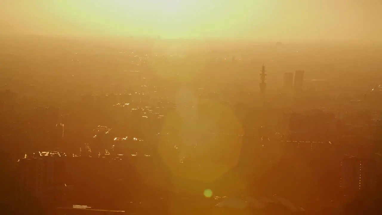 Silhouette of Milan city during golden sunset or sunrise with lens flare