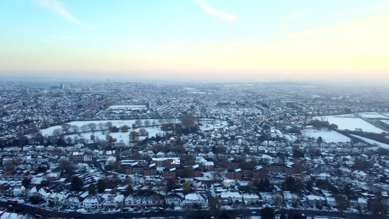 Wide angle establishing aerial shot of town covered in snow England