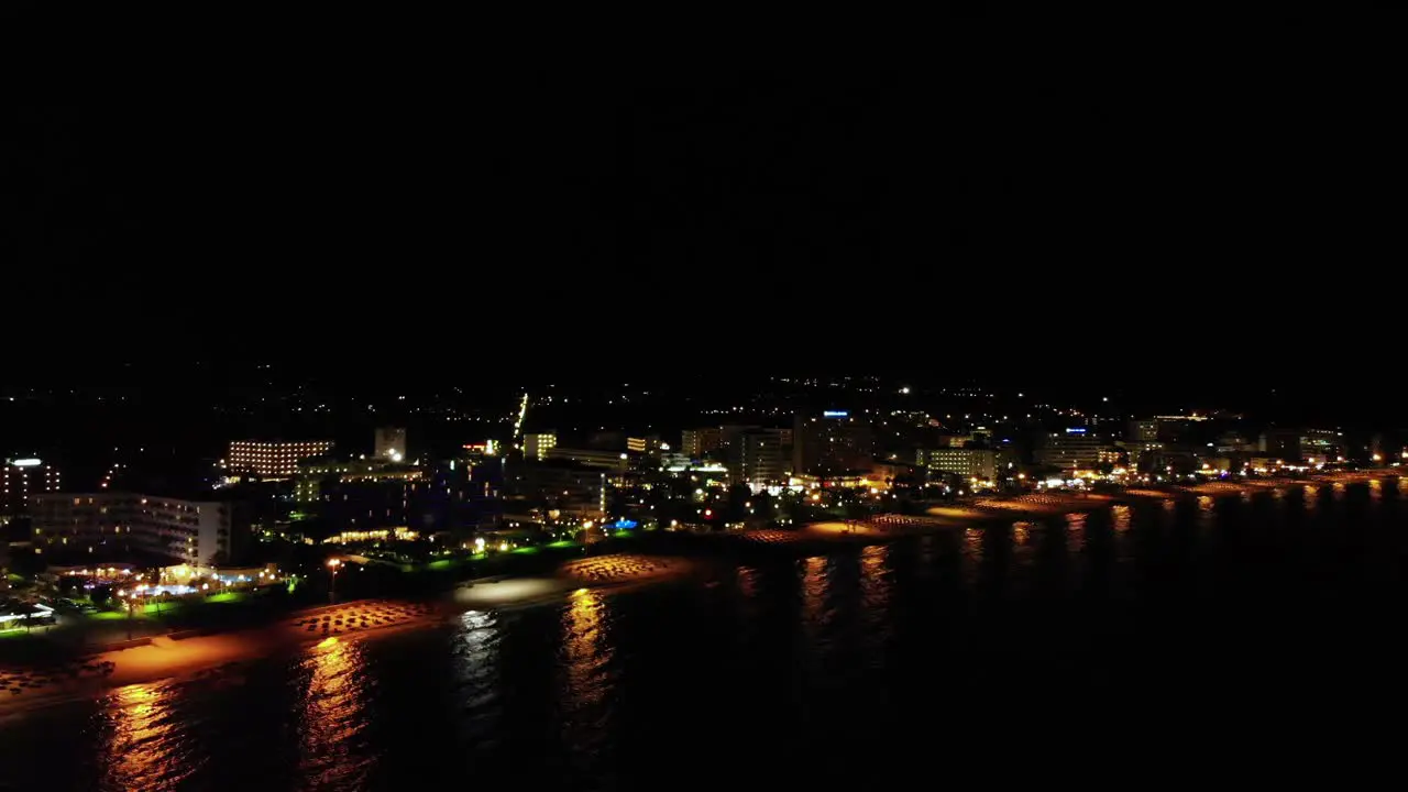 Aerial backward over coast of Balearic Mallorca island at night