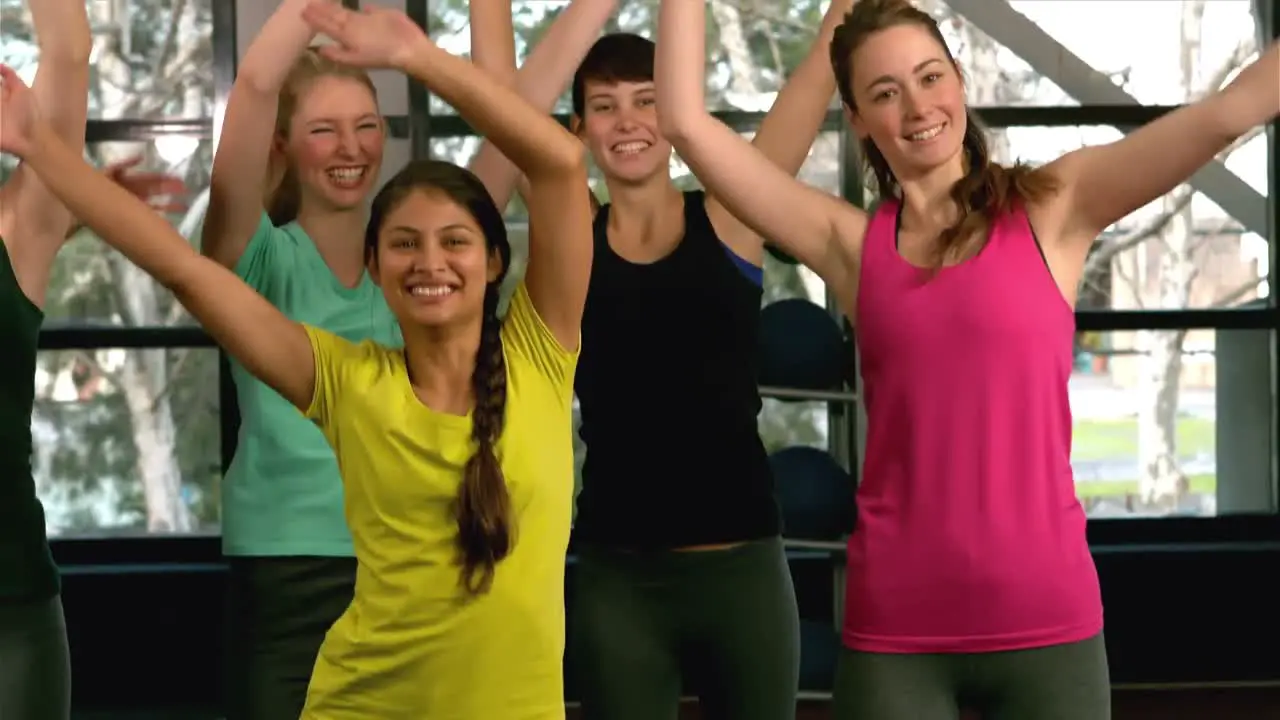 Fit woman group doing aerobic exercises at the gym