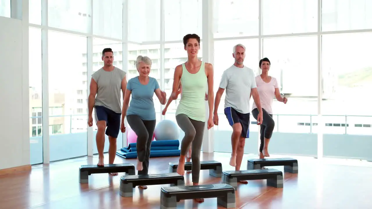 Aerobics class stepping together