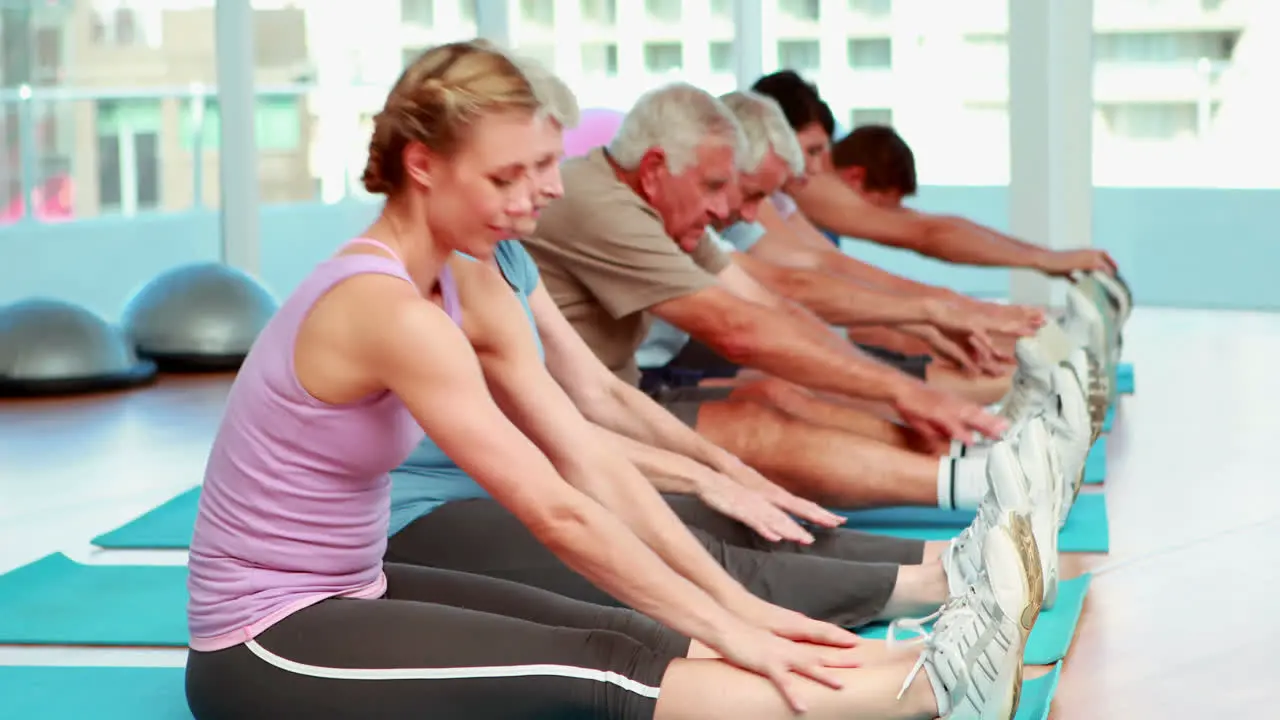 Exercise class stretching and touching their toes