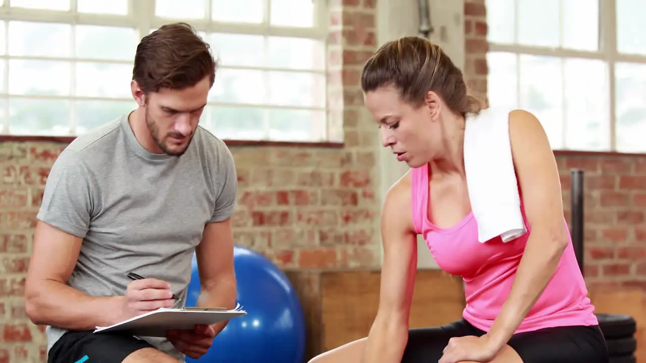 Fit woman talking to her trainer