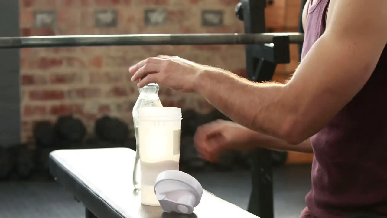 Fitness trainer making a health supplement