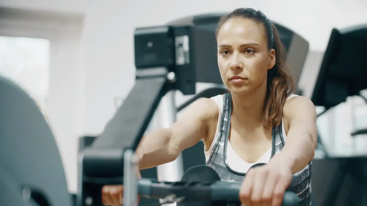 Lady Using Rowing Machine in Gym