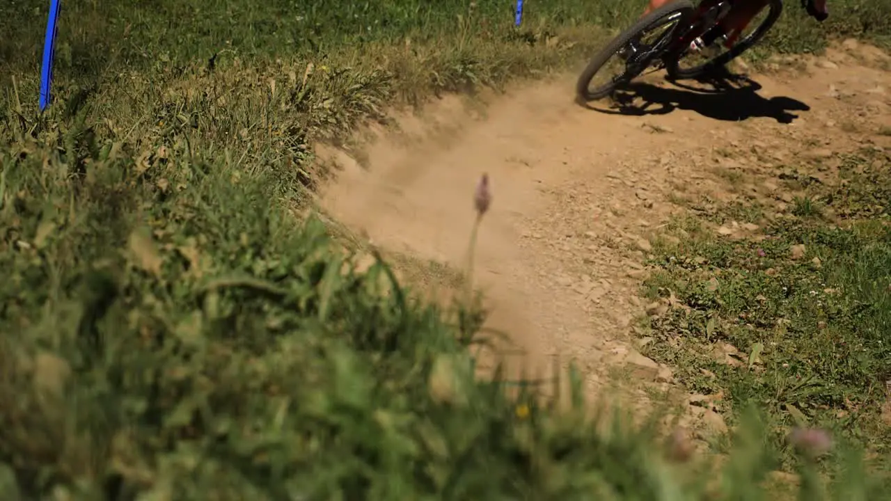 Pan of Cyclists Cycling Round Dirt Track