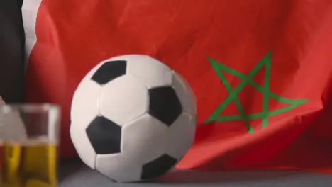 Flag Of Morocco Draped Over Sofa At Home With Football Ready For Match On TV 3