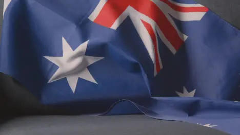 Close Up Of Flag Of Australia Draped Over Sofa At Home Ready For Match On TV