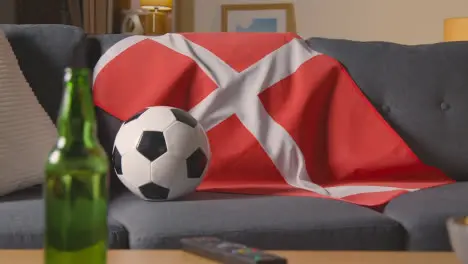 Flag Of Denmark Draped Over Sofa At Home With Football Ready For Match On TV 1