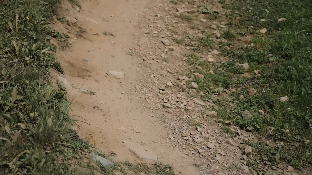 Close Up Bike Passing on Dusty Dirt Track