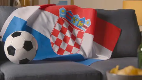 Flag Of Croatia Draped Over Sofa At Home With Football Ready For Match On TV 1