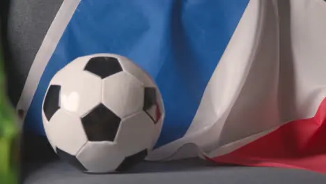 Flag Of France Draped Over Sofa At Home With Football Ready For Match On TV 2