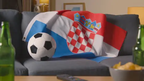 Flag Of Croatia Draped Over Sofa At Home With Football Ready For Match On TV