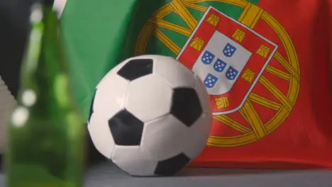 Flag Of Portugal Draped Over Sofa At Home With Football Ready For Match On TV