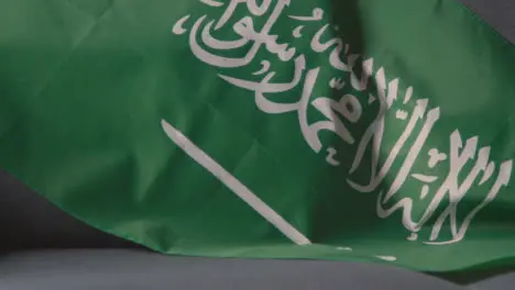 Close Up Of Flag Of Saudi Arabia Draped Over Sofa At Home Ready For Match On TV