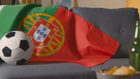 Flag Of Portugal Draped Over Sofa At Home With Football Ready For Match On TV 2