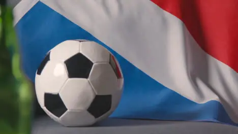 Flag Of Holland Draped Over Sofa At Home With Football Ready For Match On TV 2