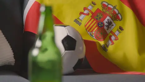 Flag Of Spain Draped Over Sofa At Home With Football Ready For Match On TV 2