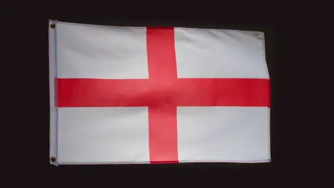 Studio Shot Of Saint George Flag Of England Flying Against Black Background