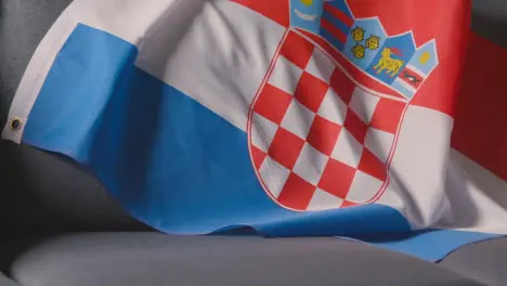 Close Up Of Flag Of Croatia Draped Over Sofa At Home Ready For Match On TV