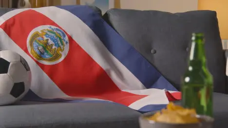 Flag Of Costa Rica Draped Over Sofa At Home With Football Ready For Match On TV 2