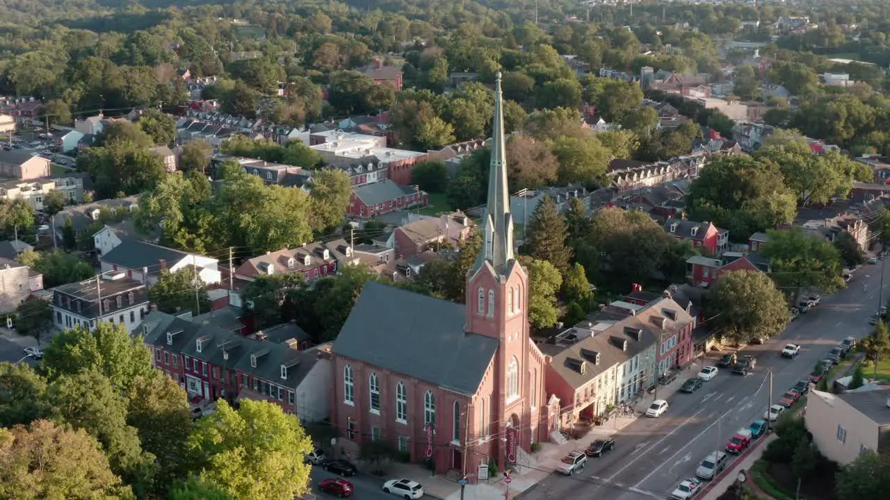 Aerial of large brick church and steeple in American urban city community