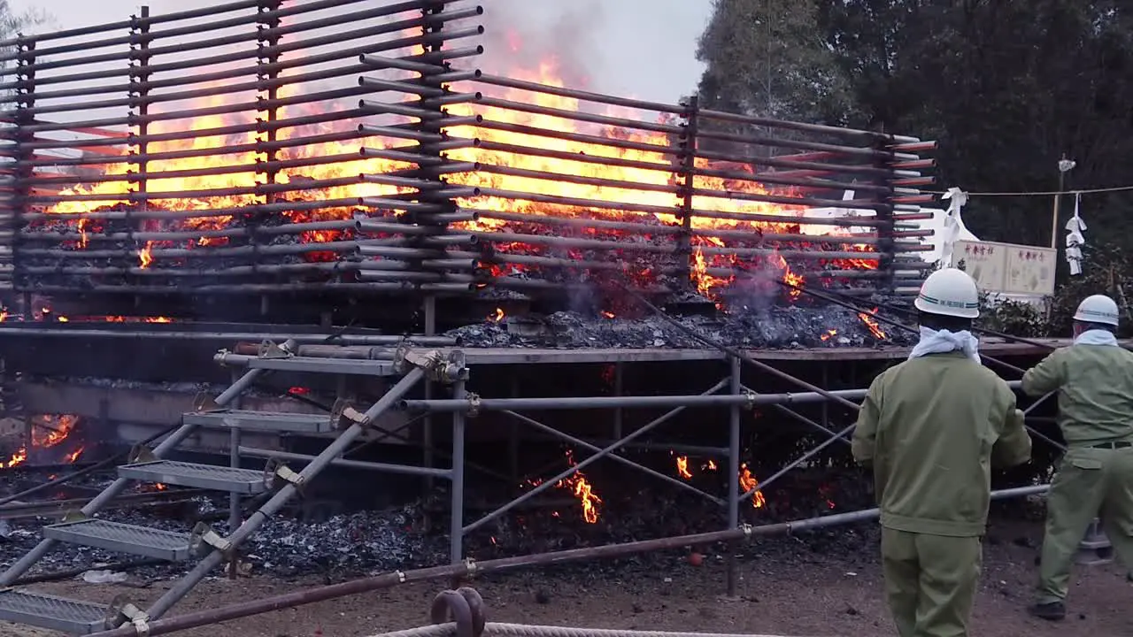 Slow motion static shot as ritual fire starts on morning of annual mountain burning event in Japan