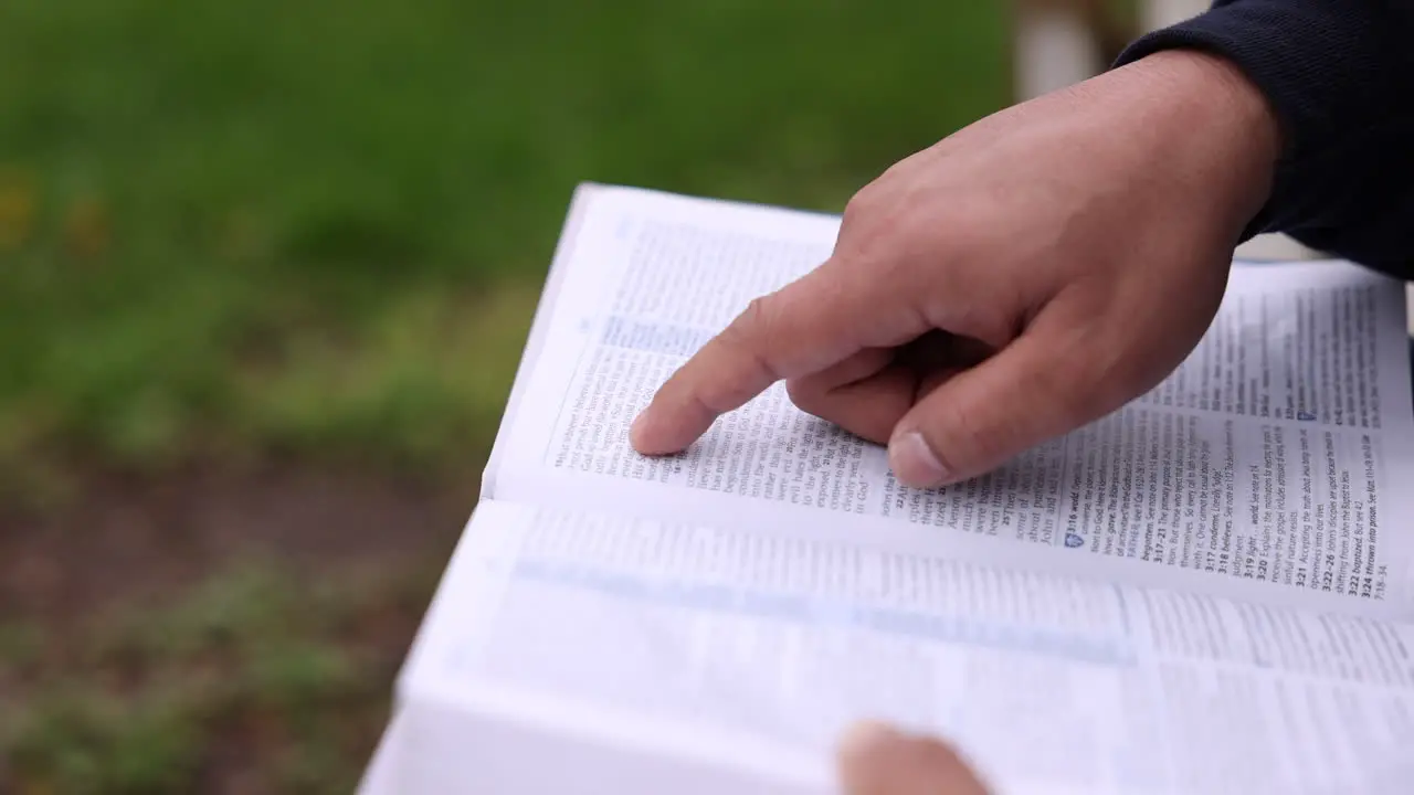 Asian Man Reading Bible Tracing With Finger Close Up Hands