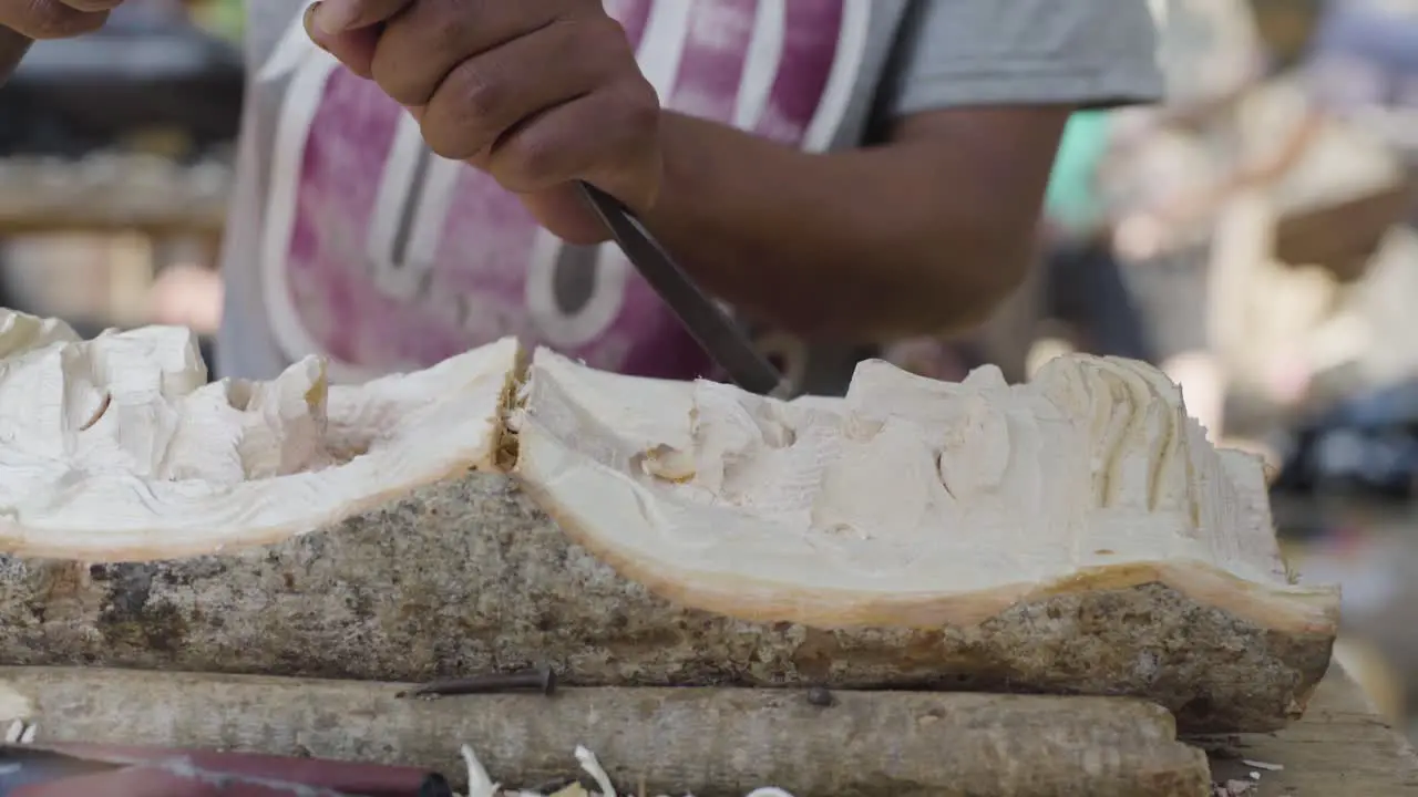 Woodcarvers in Antigua Guatemala carve souvenir wooden effigies of Jesus Christ during easter week Semana Santa 4