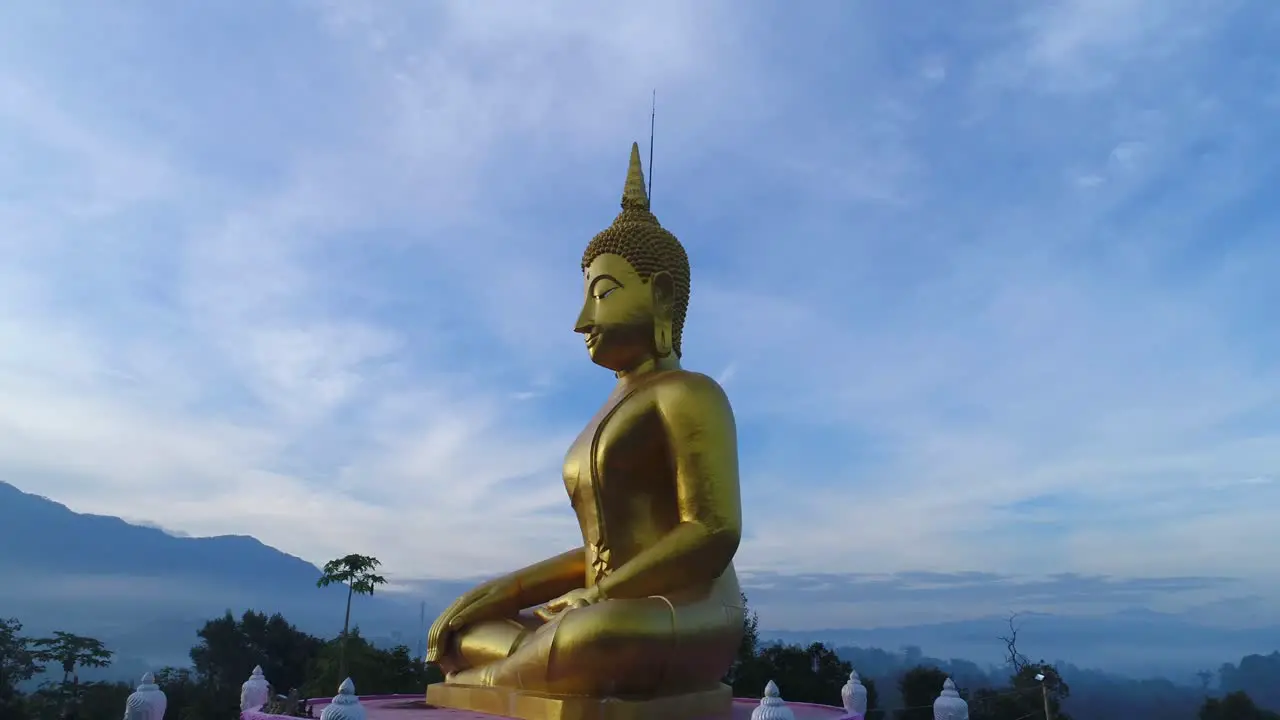 Huge Gold Budda Crane Shot Aerial Drone Statue Towering Mountians Laos Thailand Cinematic