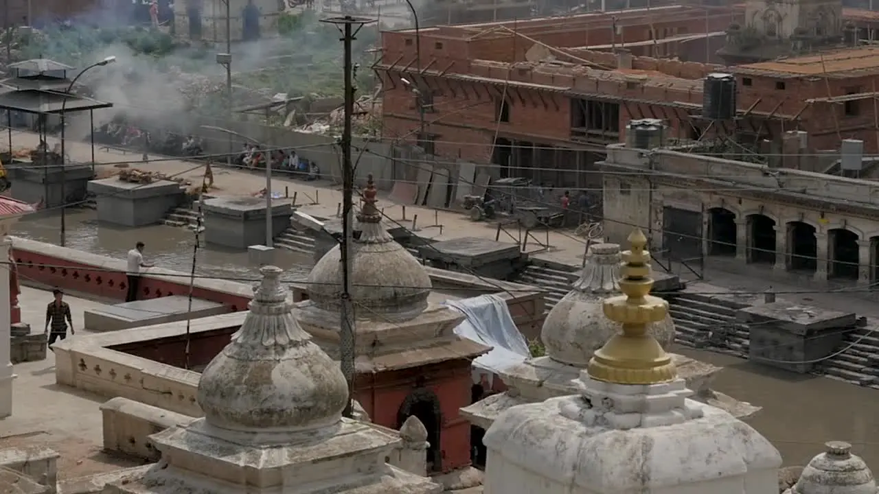 Slow Motion Pan of Pashupatinath Temple with Open Cremation Ceremonies Kathmandu Nepal