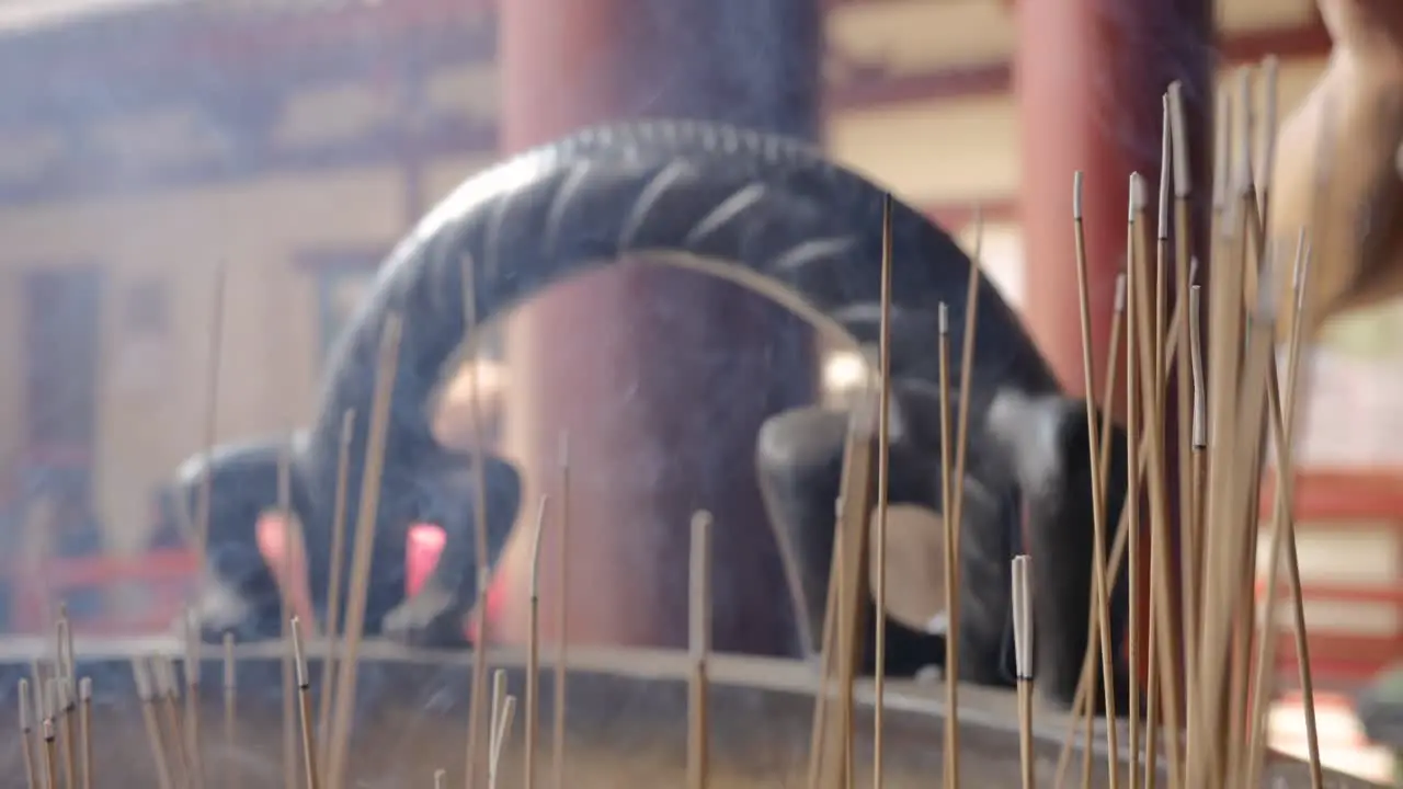 Close up shot of incense burning outside a temple in Singapore