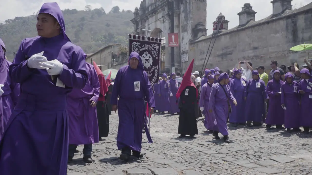 Purple robed Catholic Christian priests march in the Semana Santa Easter week holidays in Antigua Guatemala 2