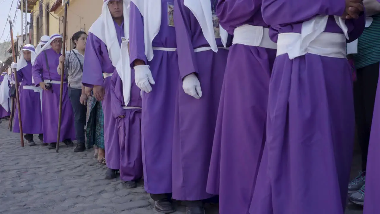 Purple robed Catholic Christian priests march in the Semana Santa Easter week holidays in Antigua Guatemala 1